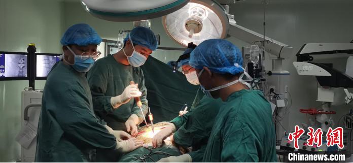 图为何蔚副主任医师及团队为患者进行手术。　拉萨市人民医院脊柱外科供图